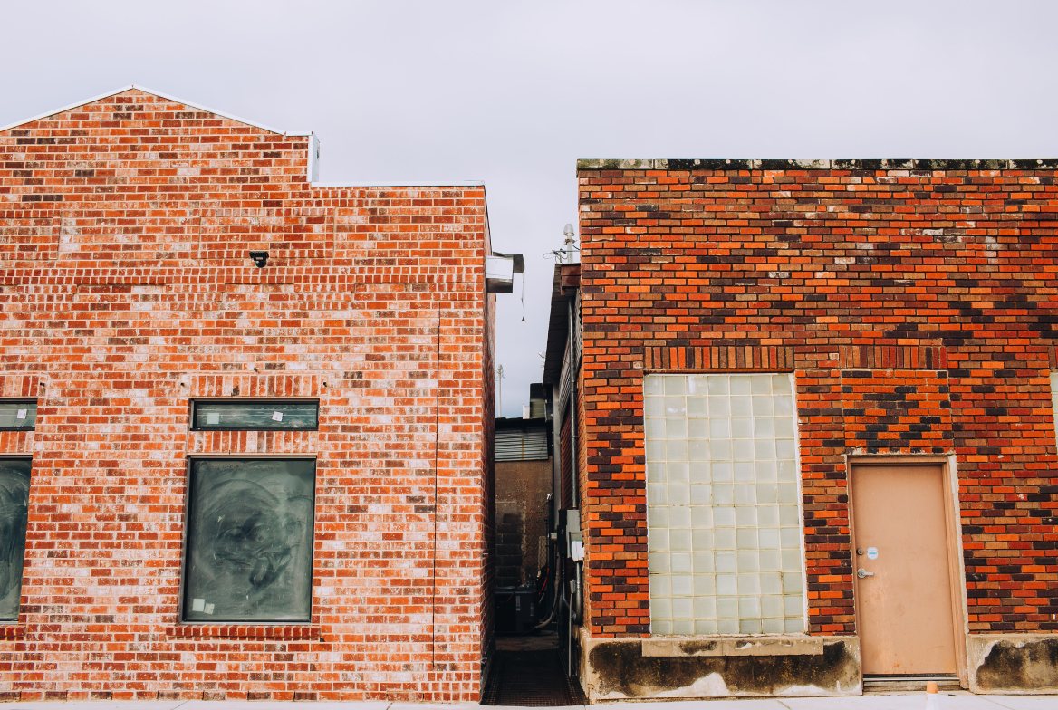 Two old brick warehouse fronts side by side