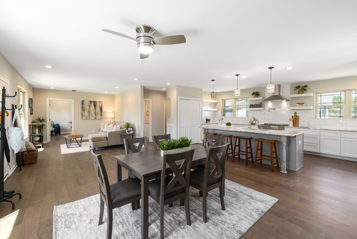 A family room and dining table open to the kitchen