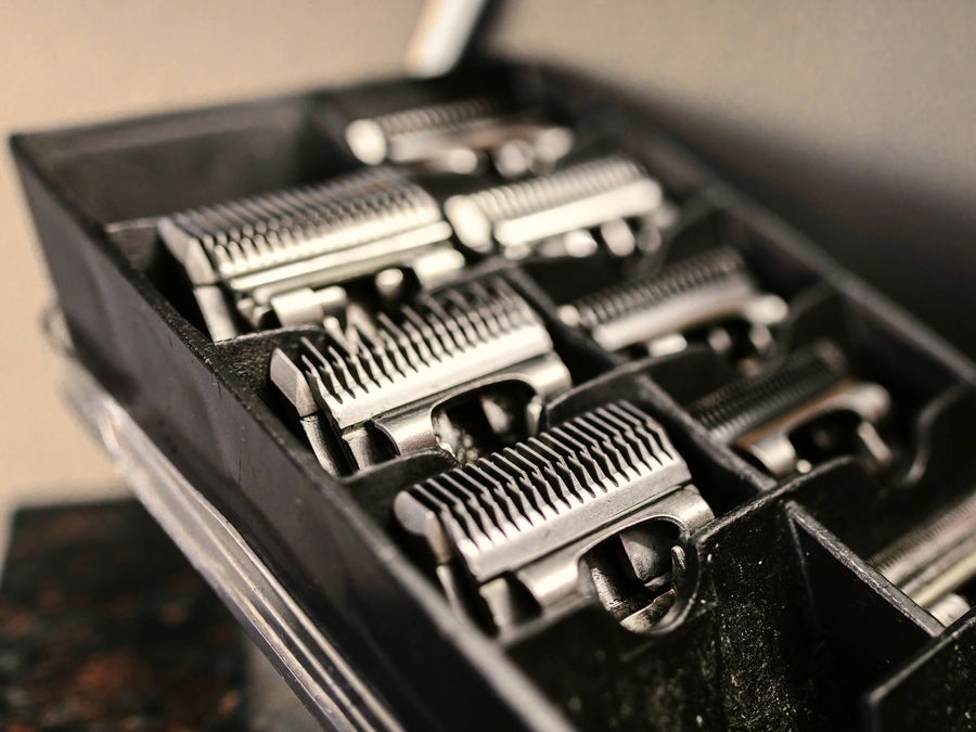 A case of steel clipper guards, lined up by size