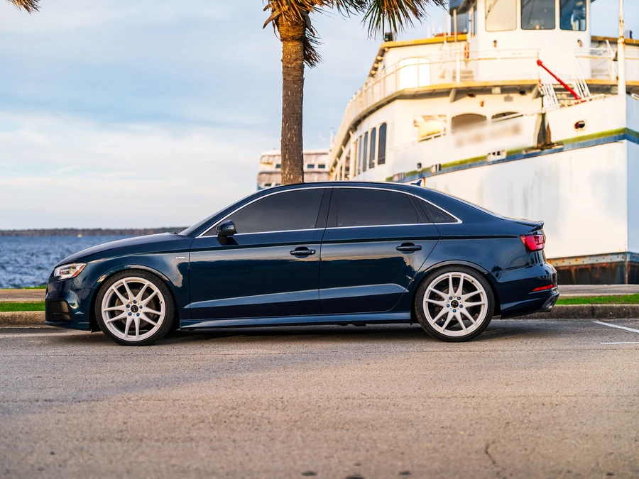 Dark sedan at the waterfront, clean finish