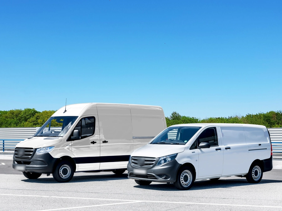 Two white work vans parked side by side